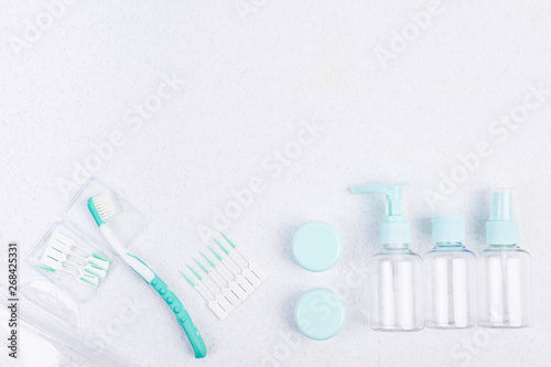 Toothbrush and plastic containers for travel on a white background and chopsticks. Flat lay.