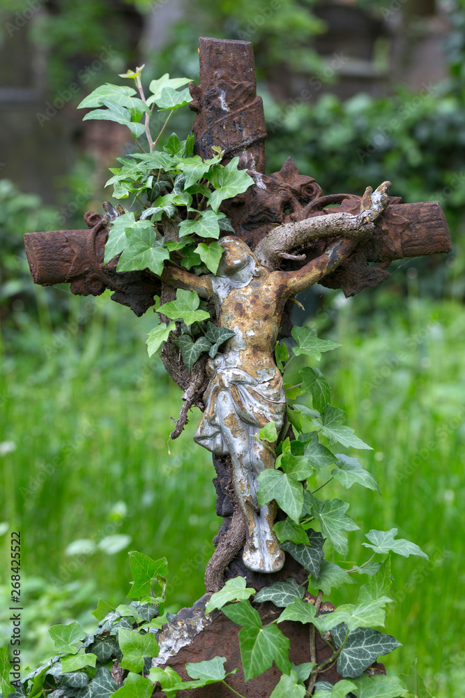 Fototapeta premium Historic Jesus on the mystery old Prague Cemetery, Czech Republic