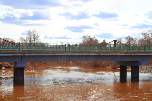 Automotive concrete bridge over the river. Close-up. Background.