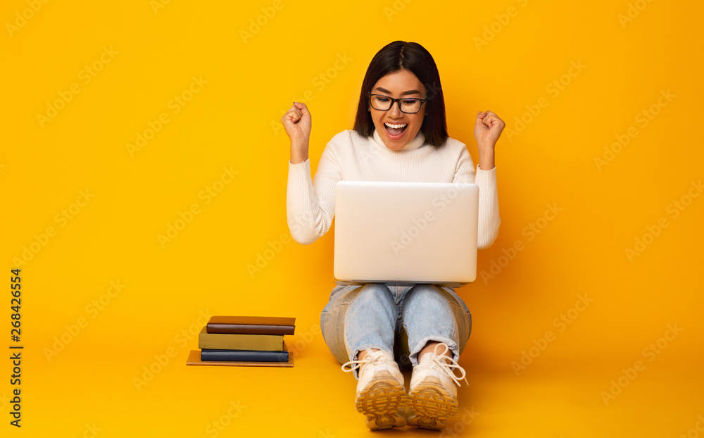 Education Concept. Happy Student Girl With Books And Laptop, Yellow Background Education Concept. Happy Student Girl With Books And Laptop, Yellow Background