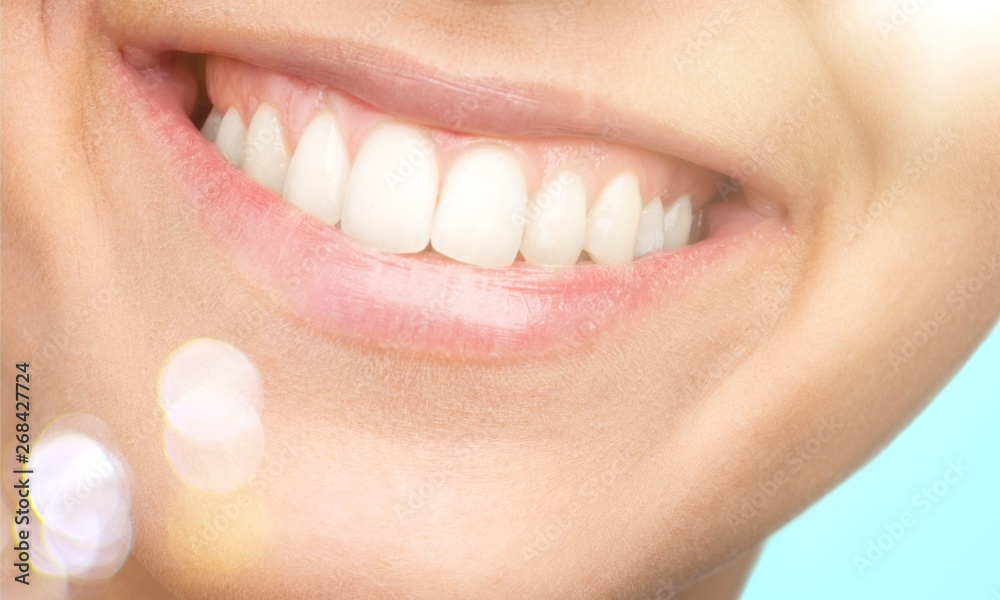 Obraz premium Beautiful wide smile of young fresh woman with great healthy white teeth. Isolated over white background