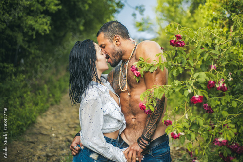 Love concept. Passion love couple. Romantic moment. Sexy couple makes love in the garden, passion. photo