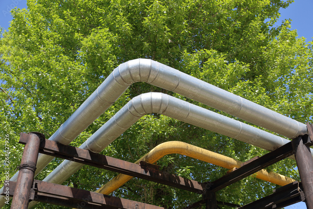 Outdoor industrial pipes of manufacturing plant on a sunny day