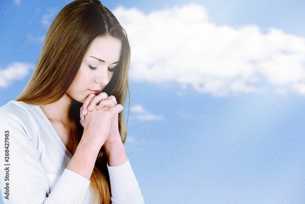 Young woman preying on light background Young woman preying on light background