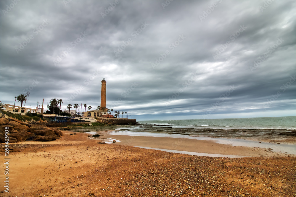 Chipiona beach, in the province of Cadiz, Spain, with the lighthouse in the background on a winter day