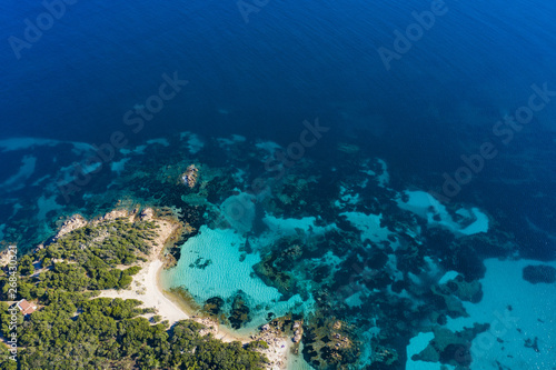 View from above, stunning aerial view of the Capriccioli Beach bathed by a beautiful turquoise sea. Costa Smeralda (Emerald Coast) Sardinia, Italy. © Travel Wild