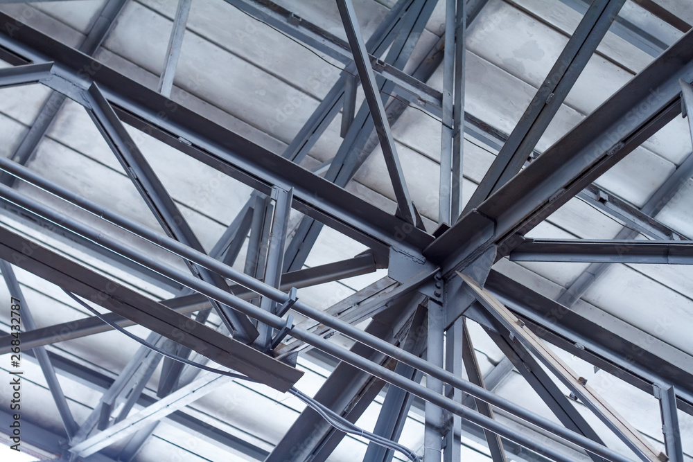 Perspective from the bottom to the frame roof of a warehouse or workshop Perspective from the bottom to the frame roof of a warehouse or workshop