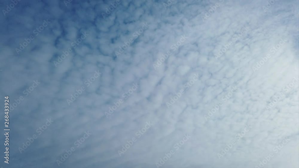 Awesome timelapse clouds with fluffy white cirrocumulusrolls in the air carried by the wind Awesome timelapse clouds with fluffy white cirrocumulusrolls in the air carried by the wind