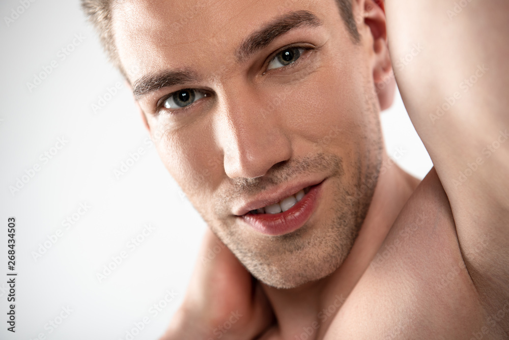 Handsome young man with stubble posing against white background Handsome young man with stubble posing against white background