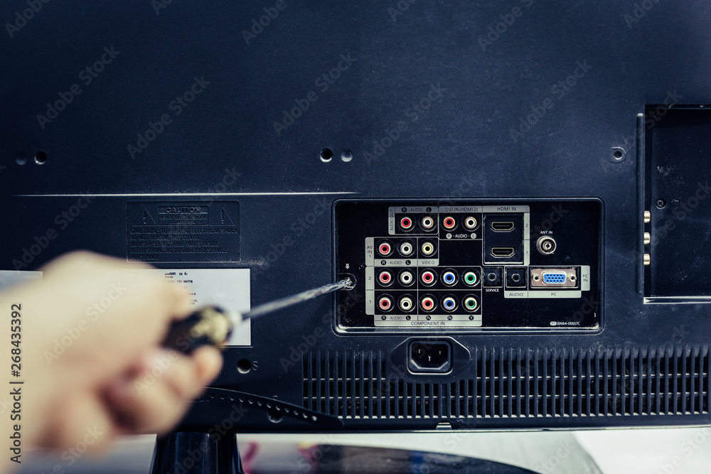 technician repairing a television technician repairing a television