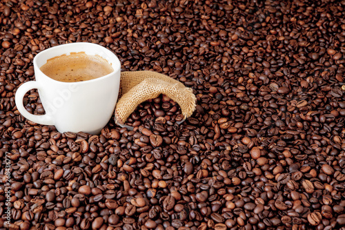 Coffee cup with coffee bag on wooden table. View from top