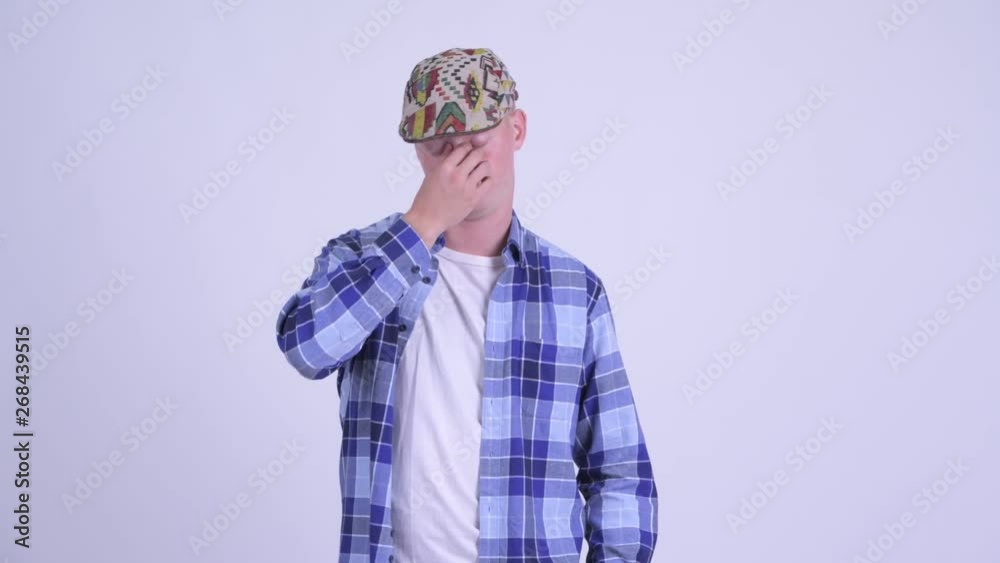 Stressed young hipster man looking bored and tired Stressed young hipster man looking bored and tired