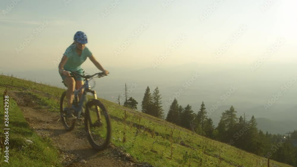 CLOSE UP: Four friends on mountain bicycles ride along a narrow mountain trail on a sunny spring morning. Group of active tourists go for a scenic bike ride in the picturesque Slovenian mountains. CLOSE UP: Four friends on mountain bicycles ride along a narrow mountain trail on a sunny spring morning. Group of active tourists go for a scenic bike ride in the picturesque Slovenian mountains.