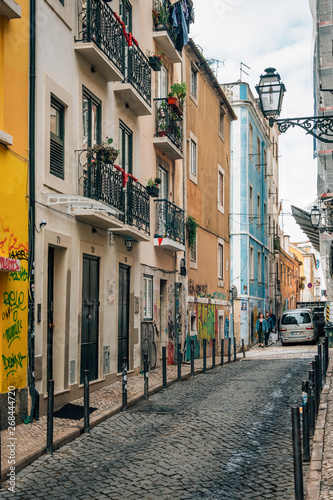 Fototapeta Naklejka Na Ścianę i Meble -  Colorful narrow cobblestone street in Bairro Alto, Lisbon, Portugal