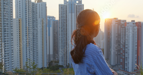 Photography Woman enjoy the view of sunset in city of Hong Kong