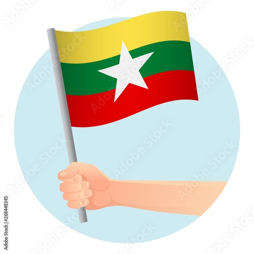 Myanmar flag in hand © Visual Content