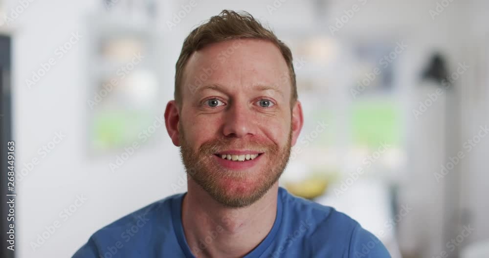 4K Close up portrait of Caucasian red haired man smiling at camera