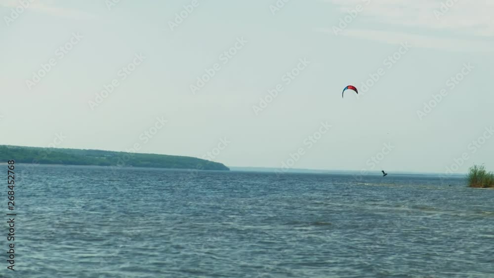 People on the river in the summer engaged in kitesurfing. Extreme sport People on the river in the summer engaged in kitesurfing. Extreme sport
