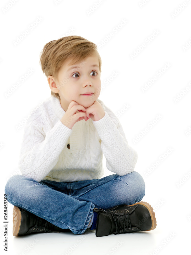 little boy is sitting on the floor little boy is sitting on the floor