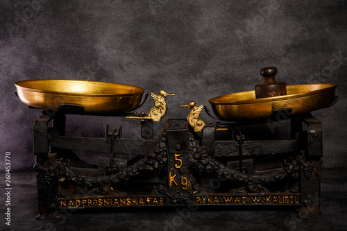 old antiquarian scales with two golden bowls and weight