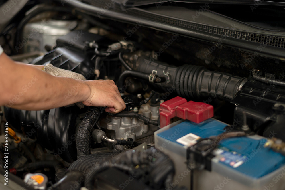 mechanic working car maintenance with soft-focus and over light in the background mechanic working car maintenance with soft-focus and over light in the background