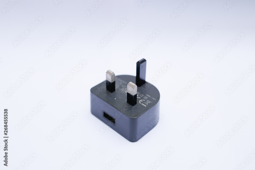 Black USB charger head/adapter isolated on a white background Black USB charger head/adapter isolated on a white background