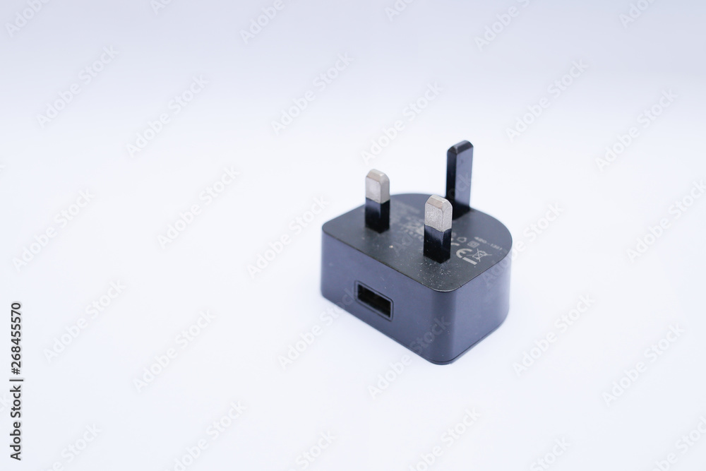 Black USB charger head/adapter isolated on a white background Black USB charger head/adapter isolated on a white background