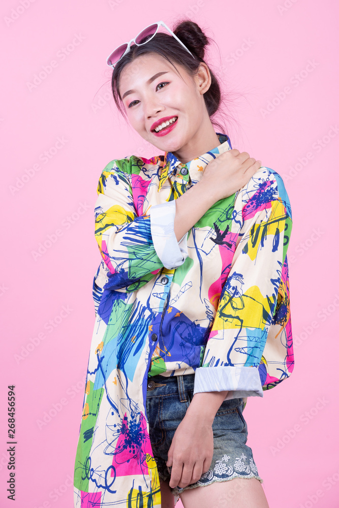Fashion girl dress up with hand gestures on a pink background. Fashion girl dress up with hand gestures on a pink background.