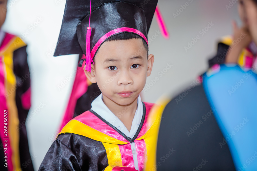 Graduation children receive a certificate. Stock Photo | Adobe Stock