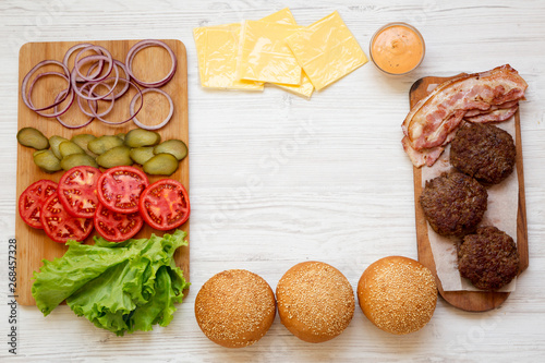 Cheeseburger ingredients, overhead view. From above, top view, flat lay. Copy space.