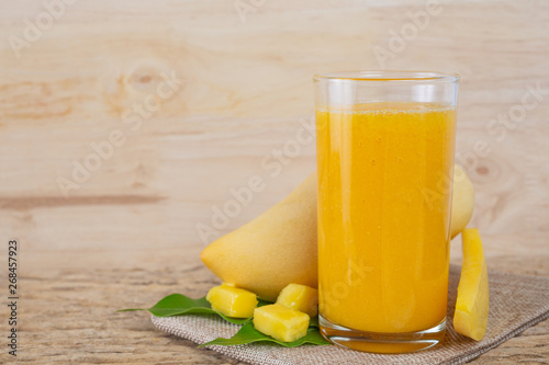 Mango juice on the wooden floor table.