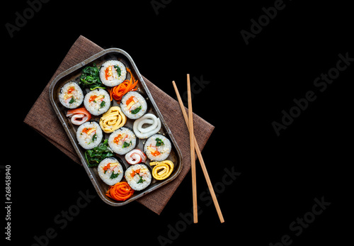Set of kimbub or sushi roll in steel plate ready to serve in korean style menu with chopstick.