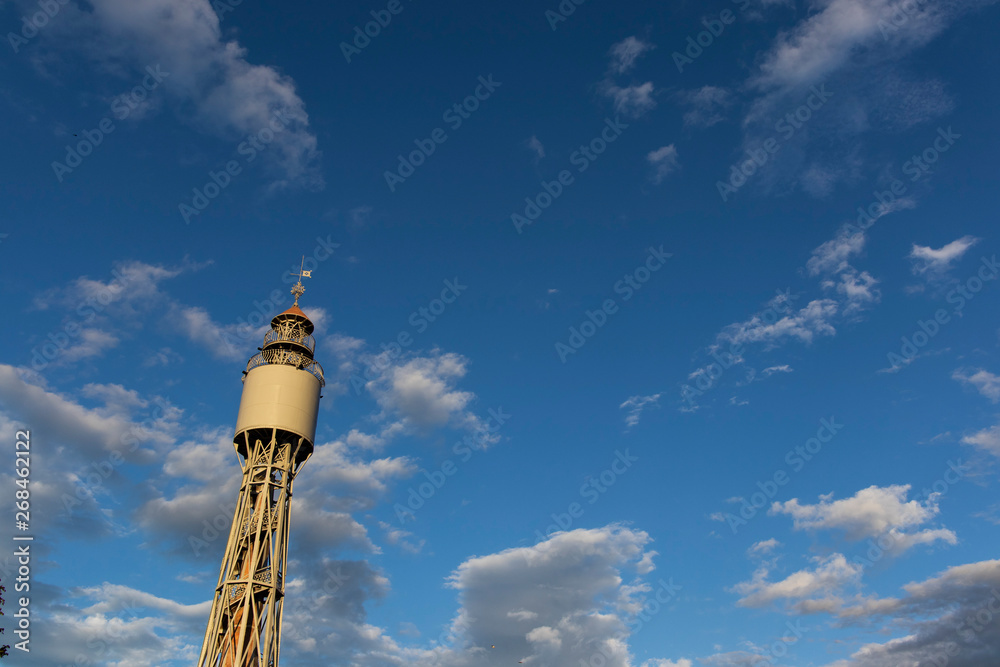 Old sightseeing tower on a blue cloudy sky