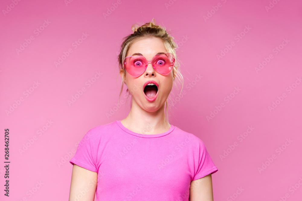 Photo of surprised blonde in pink T-shirt Photo of surprised blonde in pink T-shirt