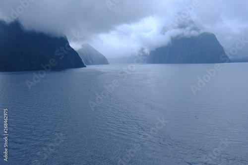 Morning sun breaking through the mist in Milford Sound