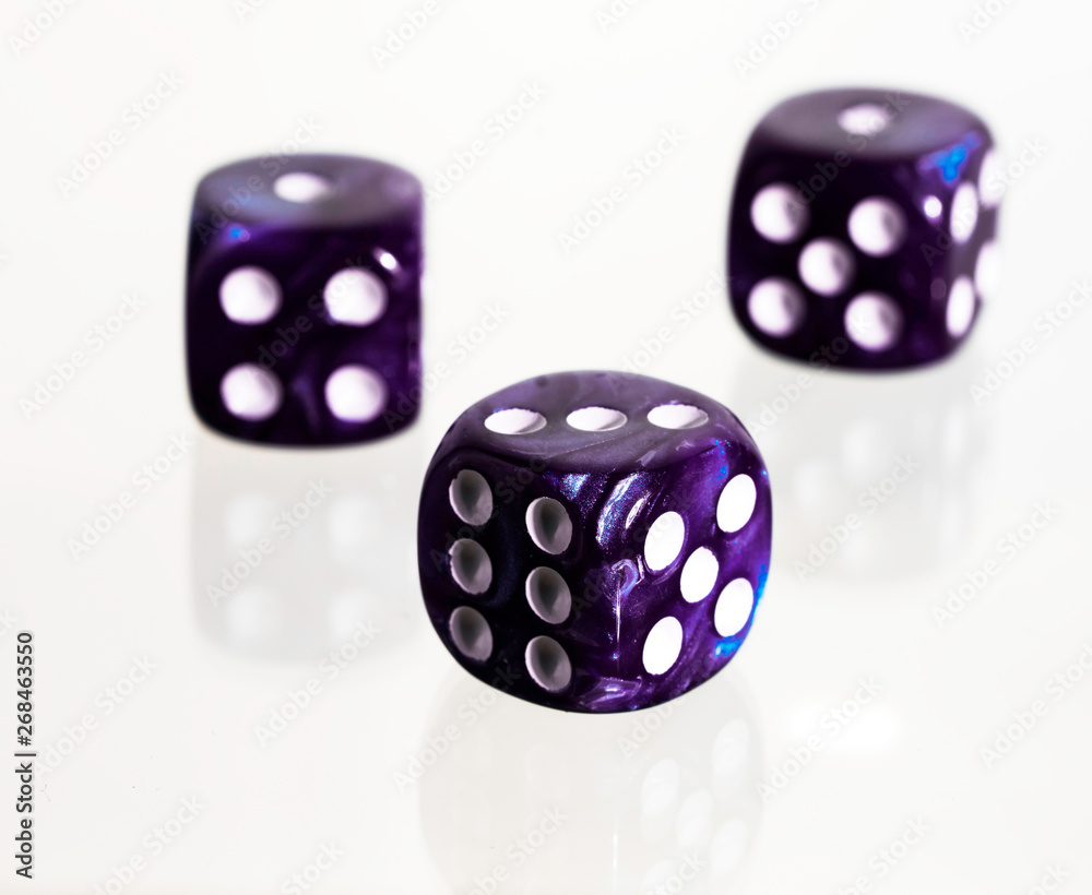 Three purple casino dice with white background Three purple casino dice with white background