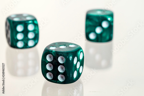 Three green casino dice with white background