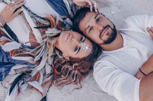 beautiful young couple lying on sand on the beach. love and relationships concept