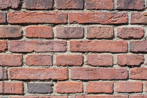 old red brick wall texture close-up background in sunlight