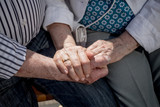 Elderly couple holding hands outdoors. Senior adults