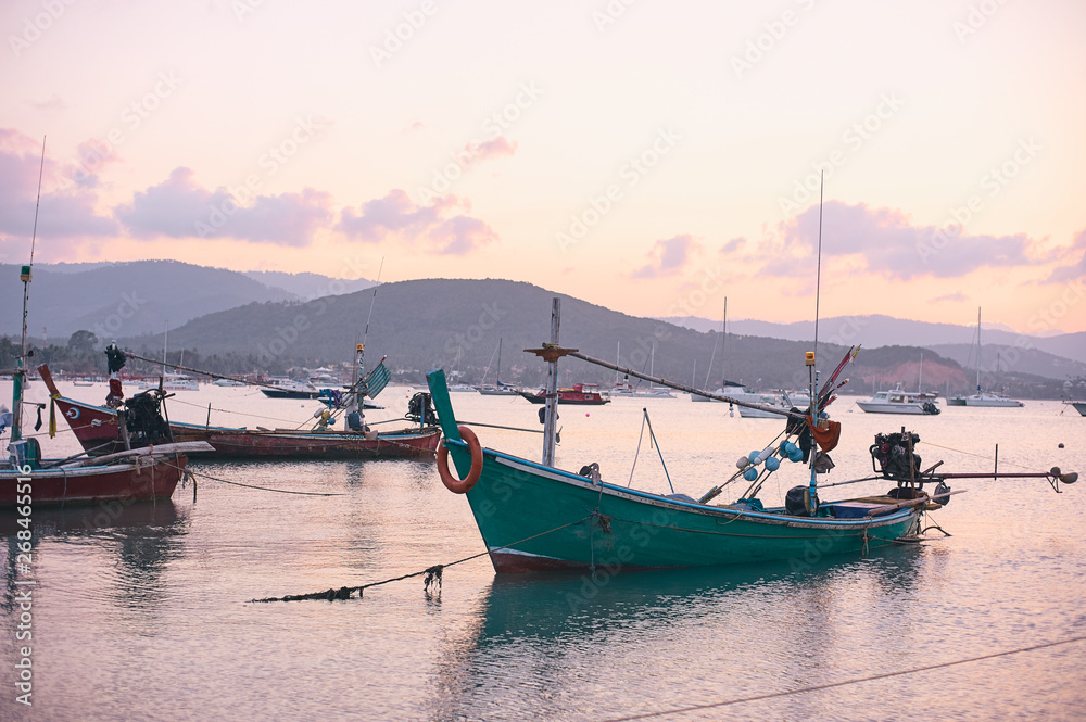 Travel by Thailand. Landscape with traditional longtail fishing boat on the sea surface.
