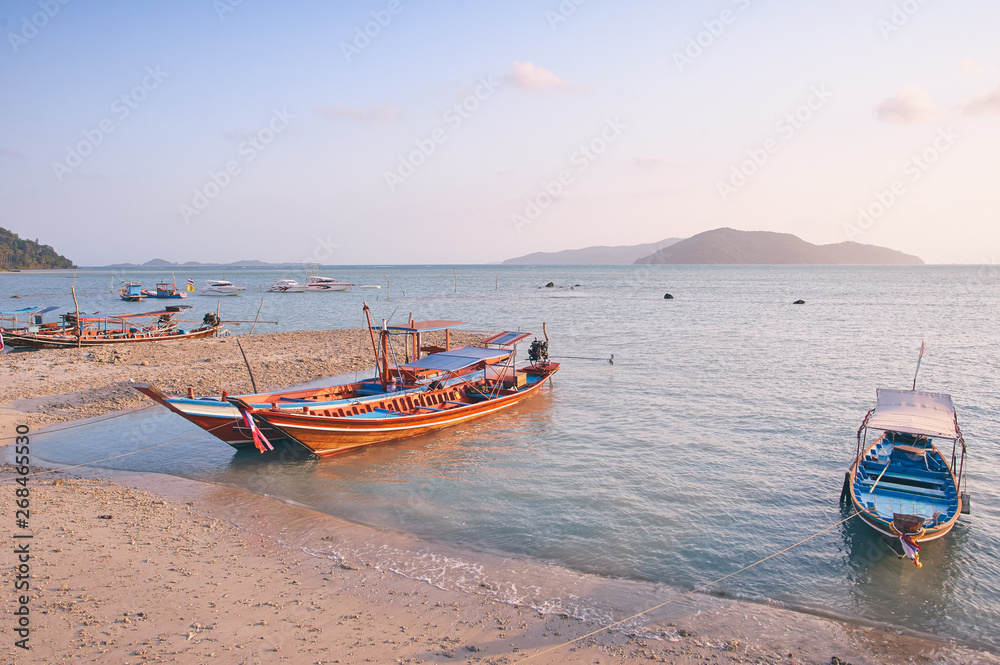 Travel by Thailand. Landscape with traditional longtail fishing boat on the sea surface.