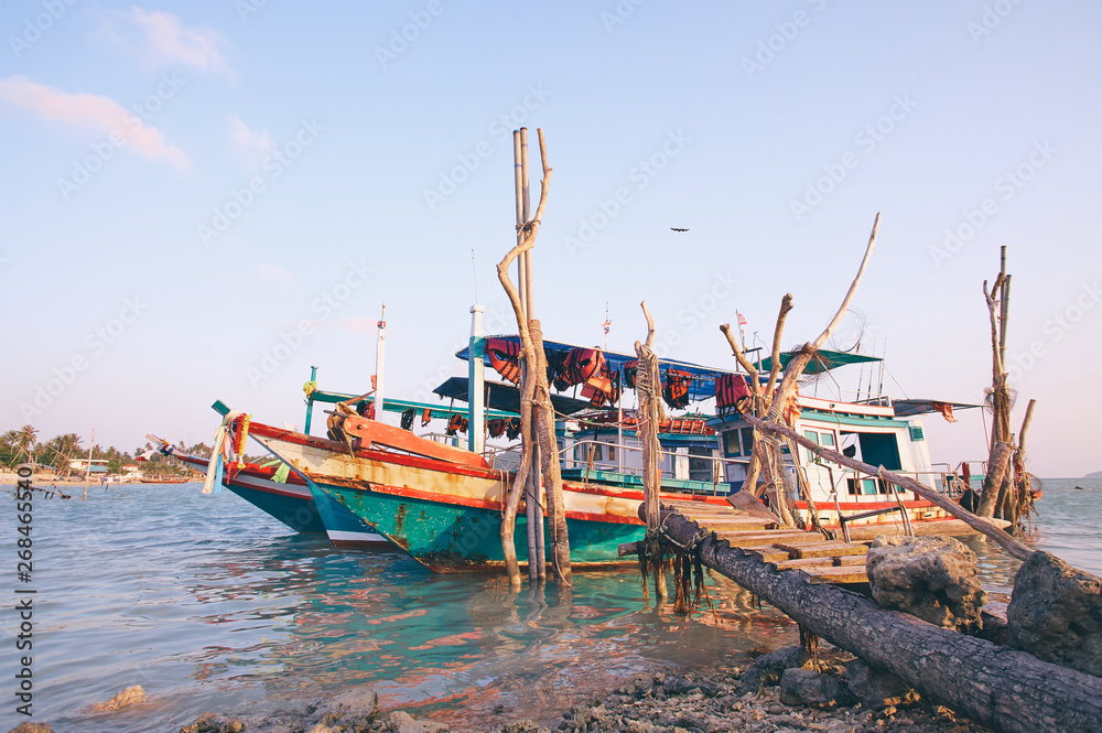 Traveling by Thailand. Ocean, beach and old fishing boat.