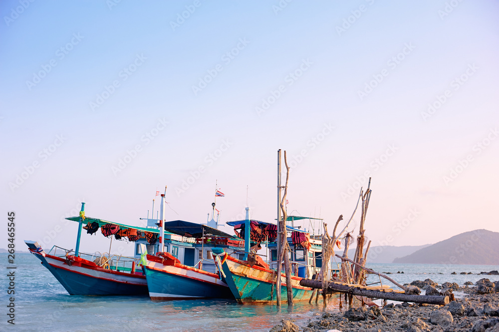 Obraz premium Traveling by Thailand. Ocean, beach and old fishing boat.