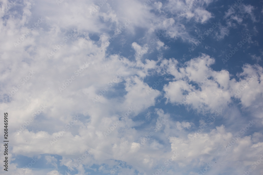 Spindrift clouds of good weather on blue sky. Fantastic skies on the planet earth. The sun is hidden. Spindrift clouds of good weather on blue sky. Fantastic skies on the planet earth. The sun is hidden.