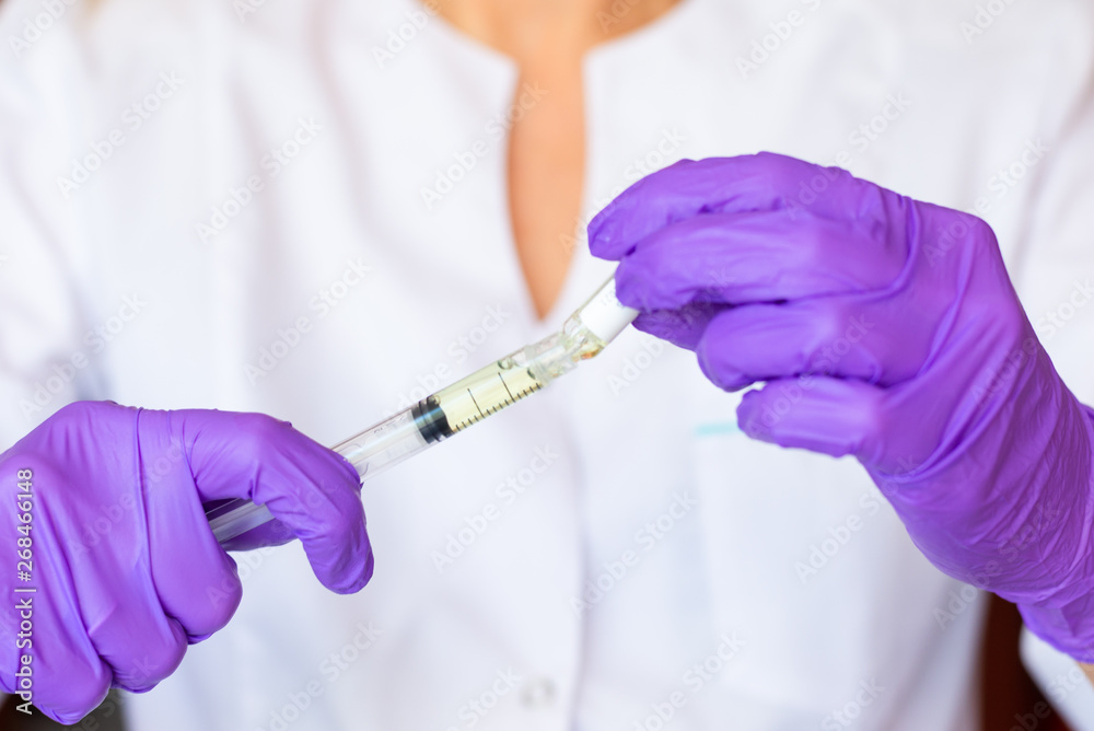 Woman hands holding syringe ampoule Woman hands holding syringe ampoule
