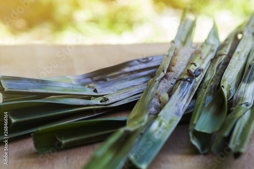 Close-up of appetizer wrapped with a Wurmb and grill on wood floor with the selected focus. photo