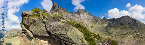 Panoramic view on tops to the Western Sayan mountains, Ergaki range, Siberia, Russia under blue sky. Best place for active life, climbing, hiking and trekking in Russia. Print poster or banner