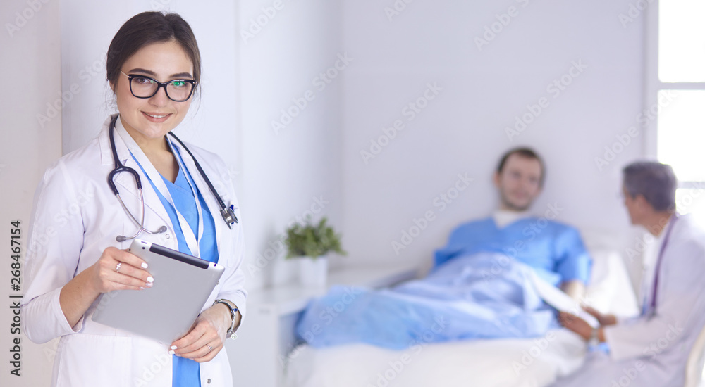 Doctor checking heart beat of patient in bed with stethoscope Doctor checking heart beat of patient in bed with stethoscope