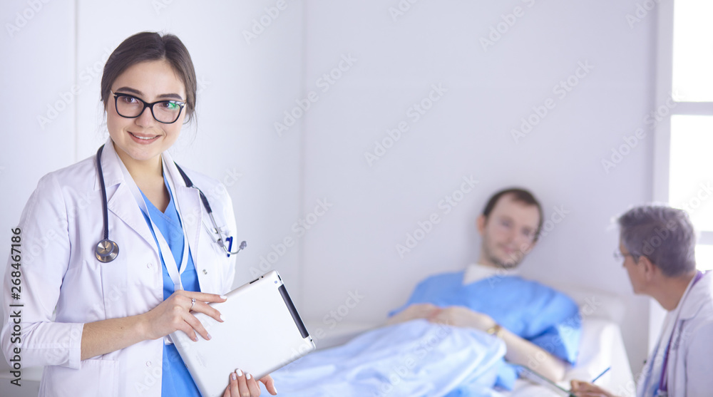 Doctor checking heart beat of patient in bed with stethoscope Doctor checking heart beat of patient in bed with stethoscope